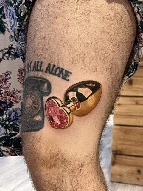 Gold butt plug by Pony Lawson at Mayday Tattoo in Chicago, IL